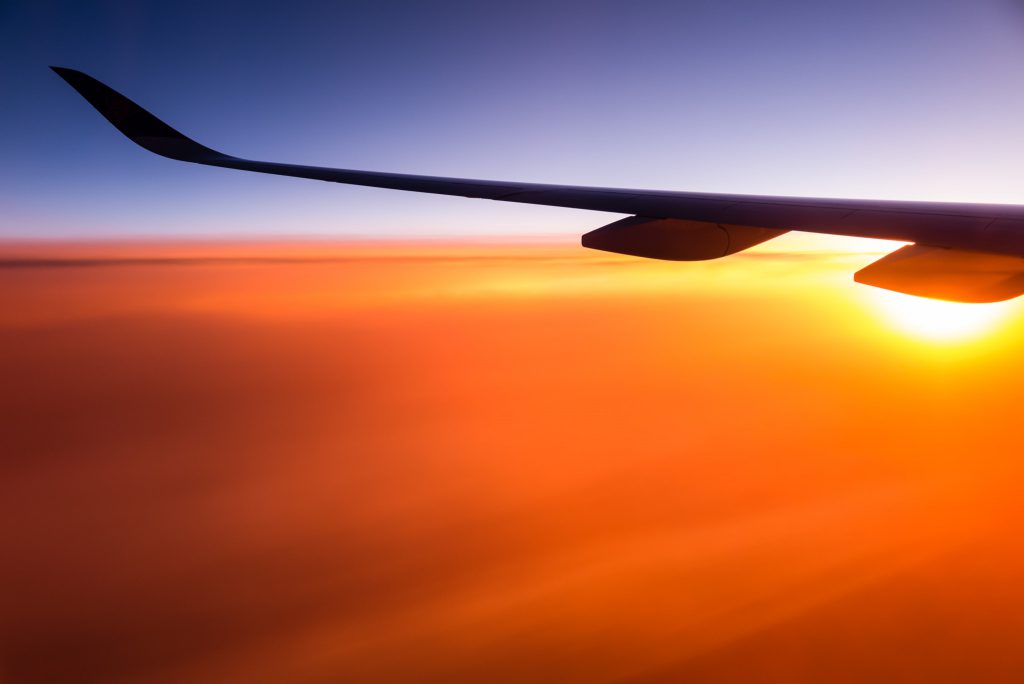 An aeroplane wing at sunset